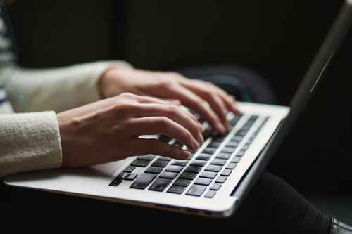 woman blogging on laptop